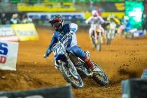 This is super-aggressive braking at a national level, but everything that is happening here is textbook style, no matter your level of speed or skill. Boots and knees gripping the bike, some bend left in the elbows, bent at the waist and head right over the triple clamp. 